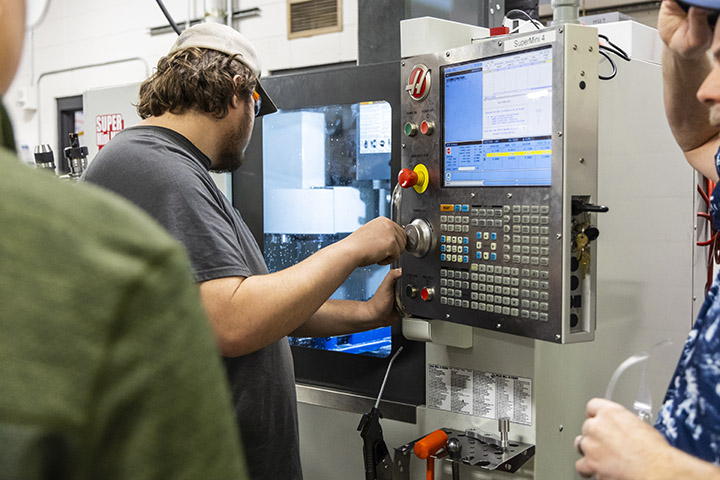 Sheridan College Machine Tool Technology Student using a CNC machine in the machine tool program