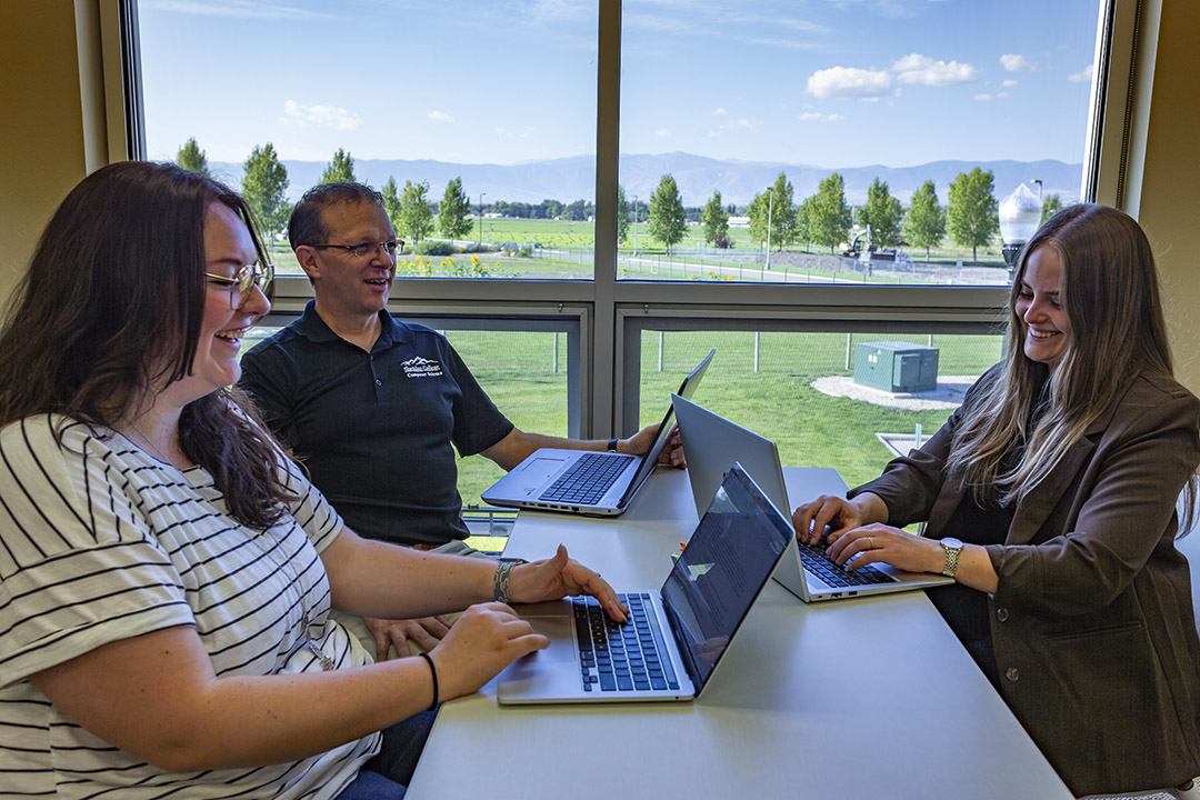 Mark and Audrey working with a Software Development student Student and instructors at Sheridan College