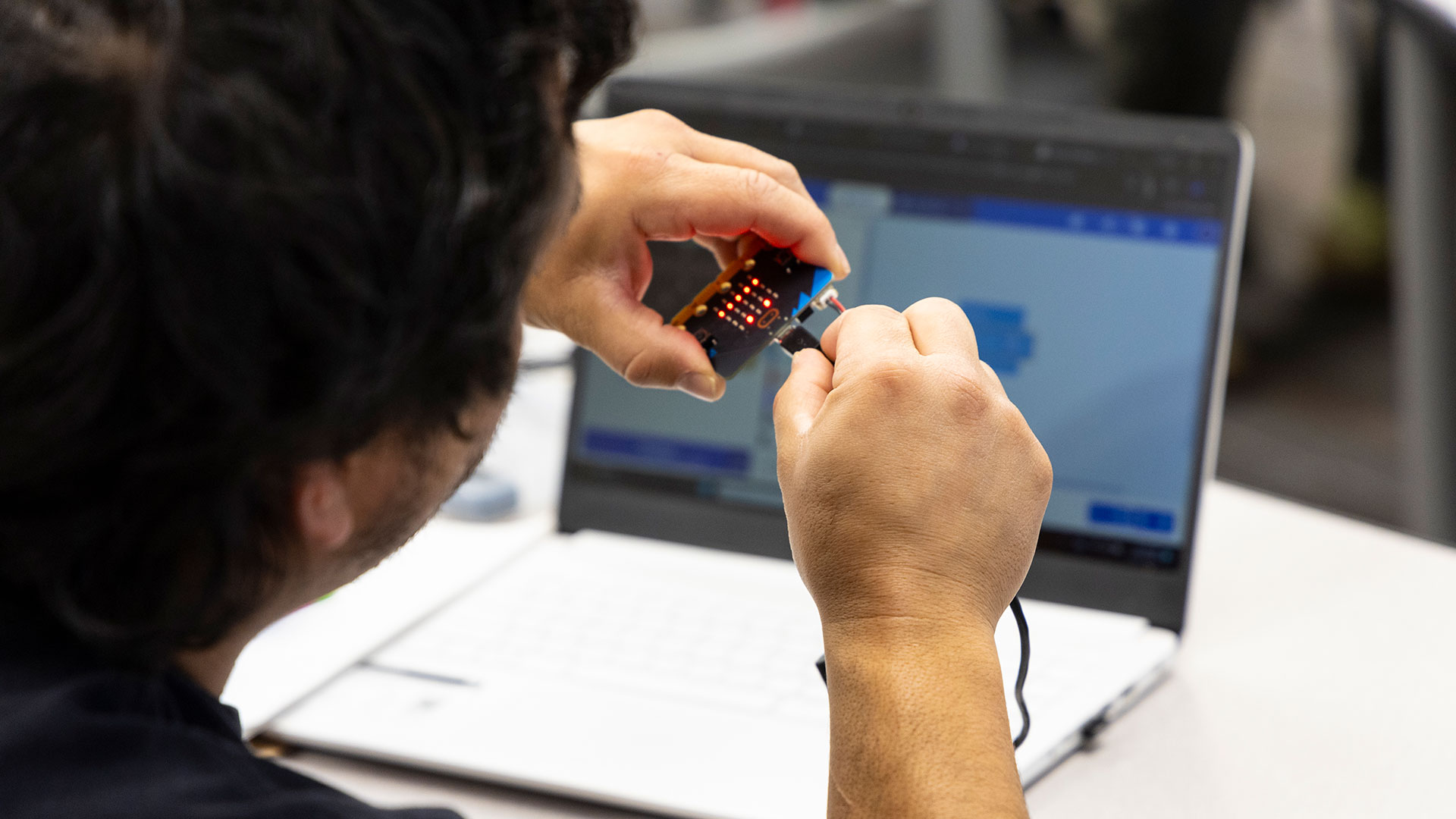 Computers_Cyber7170-1920x1080 Photo of student at Sheridan College working with computer cable.