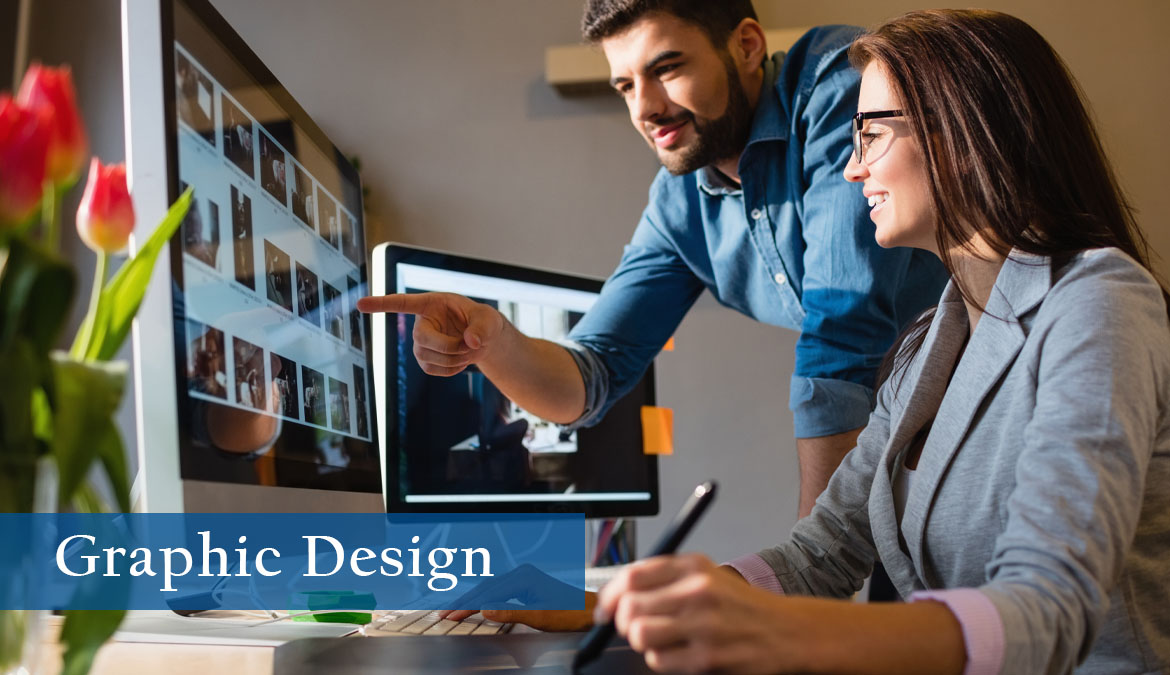 Graphic Design Two graphic designers, one male and one female, looking at a colorful computer screen with imagery.