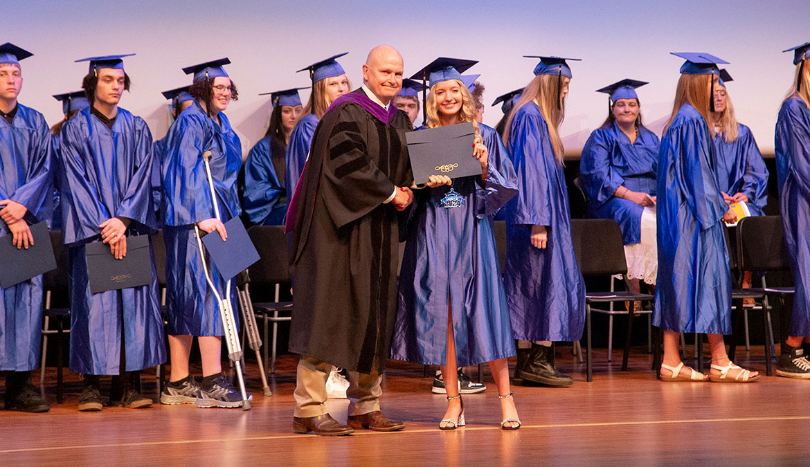 HiSetGrad_2024-9081-web Sheridan College HiSET graduation photo of new graduate excepting her diploma from President Tribley.